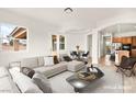 Stylishly staged living room featuring a comfortable sofa and views to the dining area at 7119 Wolf Rivers Ave, Las Vegas, NV 89131