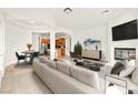 Bright living room with a fireplace, modern furnishings, and an open layout, perfect for entertaining at 7119 Wolf Rivers Ave, Las Vegas, NV 89131