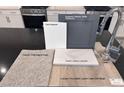 A collection of kitchen finish samples including cabinets, quartz countertop, and faucet at 9082 Rivington Ave, Las Vegas, NV 89148