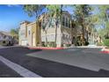 Beautiful two-story building featuring a two-car garage and well-maintained landscaping in a community setting at 10001 Peace Way # 1250, Las Vegas, NV 89147