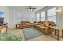 Bright living room features neutral tile flooring and leather sofas with lots of natural light at 10001 Peace Way # 1250, Las Vegas, NV 89147