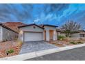 Beautiful single-story home featuring desert landscaping and a paved driveway in a serene neighborhood at 101 Mirage View Dr, Henderson, NV 89011