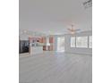 Open-concept living space with wood floors, great natural light and backyard access at 10469 Mulvaney Cir, Las Vegas, NV 89141