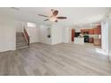 Inviting living space with wood floors that seamlessly connects living room, kitchen, and staircase at 10469 Mulvaney Cir, Las Vegas, NV 89141