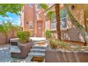 Charming front entrance with steps leading to the doorway and manicured landscaping at 10667 Olympic Pine Dr, Las Vegas, NV 89135