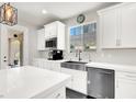 Bright kitchen with white cabinetry, stainless steel appliances, a farmhouse sink, and a view from the window at 11856 Barona Mesa Ave, Las Vegas, NV 89138