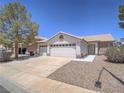 Charming single-story home with a three car garage, low maintenance landscaping, and a tile roof at 1424 Heartstring Ct, Henderson, NV 89002