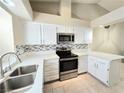 Charming kitchen with stainless steel appliances, bright white countertops and cabinetry at 2035 E Warm Springs Rd # 1017, Las Vegas, NV 89119