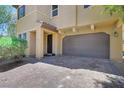 Two-story home featuring a two-car garage and inviting front entrance with a brick paved driveway at 2117 Leatherbridge Ct, North Las Vegas, NV 89081