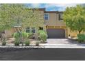 Charming home boasts a two-car garage and landscaped front yard with mature trees at 2117 Leatherbridge Ct, North Las Vegas, NV 89081