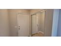 Hallway featuring neutral paint, wood-look floors, and closet doors to the right at 3151 Soaring Gulls Dr # 1074, Las Vegas, NV 89128