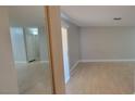 An open-concept living room with new, light-colored laminate flooring with gray walls at 3151 Soaring Gulls Dr # 1074, Las Vegas, NV 89128