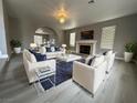 Elegant living room featuring a fireplace, modern furniture, and stylish decor at 3340 Shallow Pond Dr, Las Vegas, NV 89117