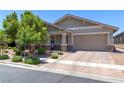 Beautiful single-story home with desert landscaping, brick accents, and a two-car garage at 379 Mano Destra Ln, Henderson, NV 89011