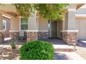 Inviting covered front porch with brick accents and a seating area at 379 Mano Destra Ln, Henderson, NV 89011