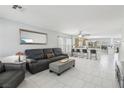 Bright and airy living room, seamlessly connected to the kitchen with a breakfast bar and modern appliances at 3966 Crystal Trip Ct, Las Vegas, NV 89129