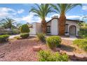 Attractive single-story house with xeriscaping, framed windows and two palm trees in the front yard at 4016 Stormcrest Dr, Las Vegas, NV 89107