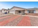 Exterior shot of single story house with a colorful brick driveway at 4386 El Cebra Way, Las Vegas, NV 89121