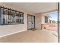 Exterior front porch featuring barred windows and security front door at 4386 El Cebra Way, Las Vegas, NV 89121