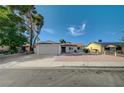 Charming single-story home with mature tree, wide driveway, and desert landscaping at 4496 Skyview Dr, Las Vegas, NV 89104