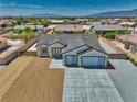 Aerial view of a stunning single-story home featuring desert landscaping and mountain views at 4861 Ridgewood, Pahrump, NV 89061