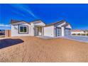 Beautiful single-story home features desert landscaping and modern garage doors at 4861 Ridgewood, Pahrump, NV 89061