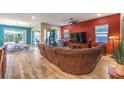 Spacious living room with hardwood floors, a large sectional sofa, and sliding glass doors to the patio at 489 Open Hill Ave, Henderson, NV 89011