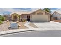 Single-story home with desert landscaping, covered entry, and a two-car garage at 5116 Blue Onion Cir, North Las Vegas, NV 89031
