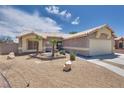 A single-story house featuring desert landscaping and a two-car garage at 5116 Blue Onion Cir, North Las Vegas, NV 89031