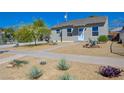 Well-kept single-story house with a xeriscaped yard featuring desert plants and rock accents at 524 Hopi Pl, Boulder City, NV 89005
