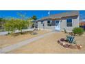 Inviting single-story home displaying a tidy xeriscaped yard and a simple walkway to the entrance at 524 Hopi Pl, Boulder City, NV 89005