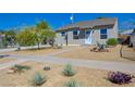 Charming single-story home featuring a xeriscaped front yard and walkway at 524 Hopi Pl, Boulder City, NV 89005