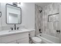 Bright bathroom offers a shower-tub, modern vanity with black fixtures, and updated tile at 5279 Consul Ave, Las Vegas, NV 89142