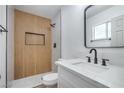 Modern bathroom featuring a walk-in shower with vertical tiling and new fixtures at 5279 Consul Ave, Las Vegas, NV 89142