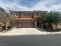 Two-story home with a three-car garage, well-manicured landscaping, and a welcoming curb appeal at 530 Calahonda Ct, Las Vegas, NV 89138