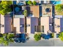 Aerial view of neighborhood homes, showcasing the roofs, driveways, backyards, and mature trees at 5984 Emerald Canyon Dr, Las Vegas, NV 89142