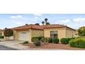 Charming one-story home showcasing well-maintained landscaping, a two-car garage, and a classic red tile roof at 7232 Vista Bonita Dr, Las Vegas, NV 89149