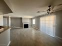 Large living area with fireplace, wood floors, and ceiling fan at 8600 W Charleston Blvd # 2033, Las Vegas, NV 89117