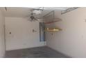 Clean and well-maintained garage interior featuring a ceiling fan, shelving and water heater at 864 Chianti Way, Mesquite, NV 89027