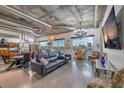 Modern living room with concrete ceilings, industrial ductwork, and expansive windows with city views at 900 S Las Vegas Blvd # 1208, Las Vegas, NV 89101