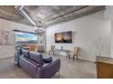 Stylish living room with city views, industrial ductwork, chandelier lighting, and comfortable seating at 900 S Las Vegas Blvd # 1208, Las Vegas, NV 89101
