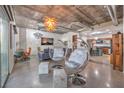 Bright living space with unique bubble chairs, chandelier, ductwork, and partial kitchen view at 900 S Las Vegas Blvd # 1208, Las Vegas, NV 89101