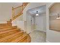 Welcoming foyer with wood staircase, tile flooring, and access to various areas of the home at 10311 Birch Bluff Lane Ln, Las Vegas, NV 89145