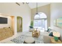 Bright living room with high ceilings, large window, neutral decor, and stylish furniture, perfect for relaxation at 10311 Birch Bluff Lane Ln, Las Vegas, NV 89145