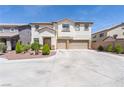 Inviting two-story home featuring a spacious three-car garage and well-manicured front yard at 11134 Casala Ct, Las Vegas, NV 89141