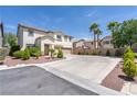 Inviting two-story home featuring a spacious three-car garage and well-manicured front yard at 11134 Casala Ct, Las Vegas, NV 89141