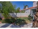 A well-maintained backyard featuring lush green grass and mature trees at 185 Camrose St, Henderson, NV 89074