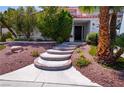 A beautiful front entrance welcomes you with custom stairs and desert landscaping at 185 Camrose St, Henderson, NV 89074