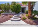 A beautiful front entrance welcomes you with custom stairs and desert landscaping at 185 Camrose St, Henderson, NV 89074
