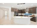Gourmet kitchen with sleek cabinetry, stainless steel appliances, and a large island with seating at 19 Desert Ivy Ln, Henderson, NV 89011